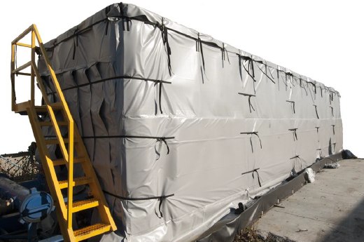Frac tank fully wrapped in a Powerblanket heating and insulation blanket system, with yellow access stairs