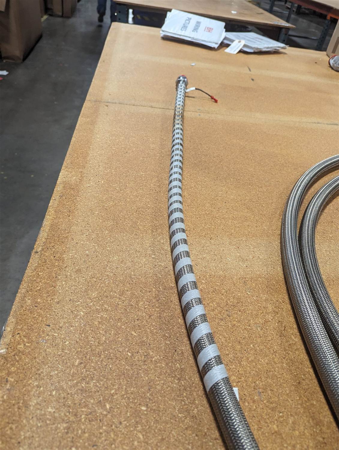 Macro shot of a stainless overbraid jacket on two finished heated lines