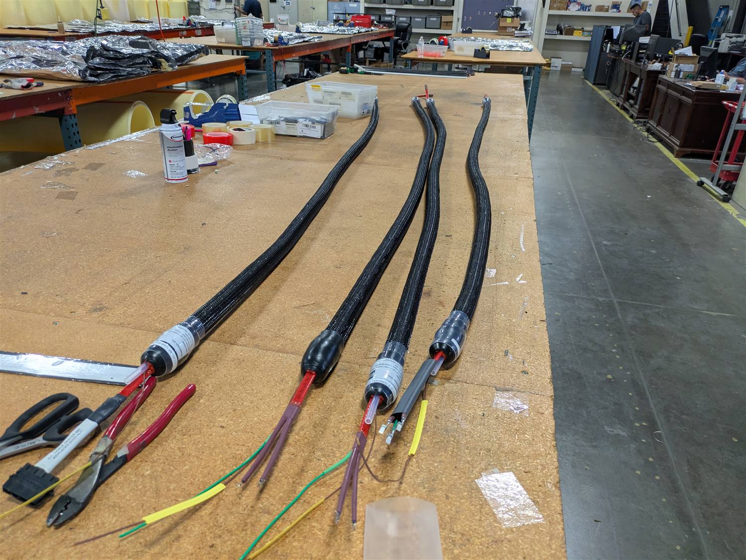 Four finished heated sample lines laid parallel on a workbench