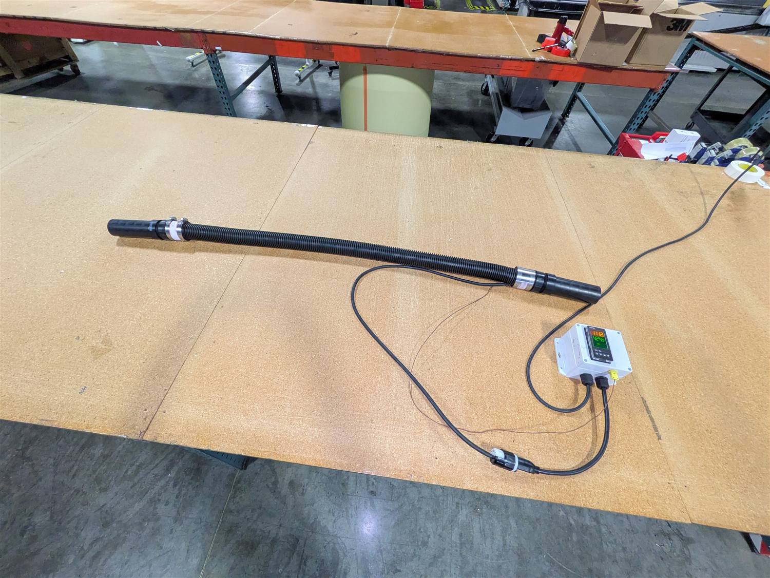 Heated sample line wired to a temperature controller showing a live readout